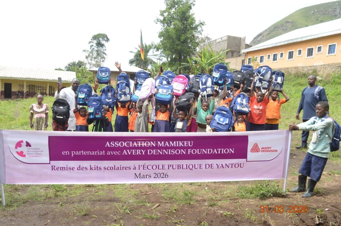 Pupils of Yantou Public School holding up the school kits they have just received
